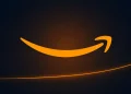 Amazon smile-arrow on a dark background illustrating the Amazon share price rally after strong AWS growth.